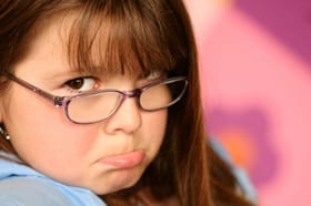 girl with eye glasses pouting