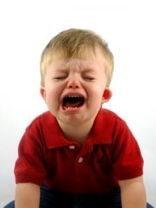 little boy with red polo shirt tantrums