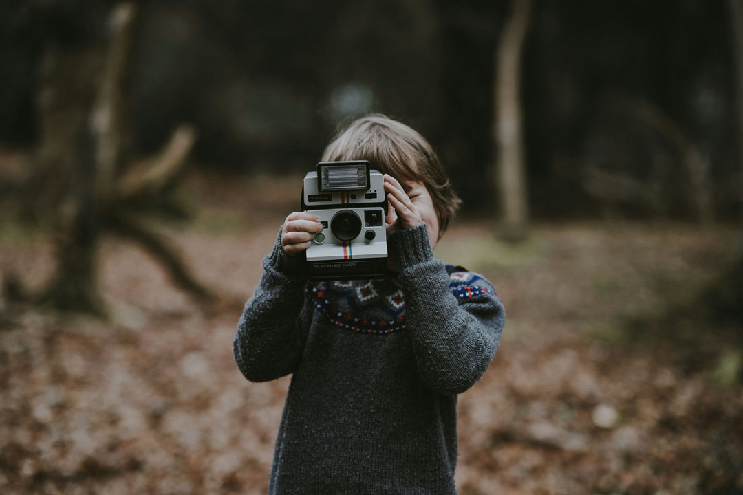 boy-holding-polaroid-camera-by-annie-spratt-at-unsplash