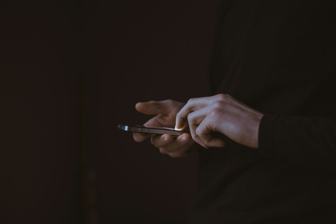 man-scrolling-his-smart-phone-by-gilles-lambert-at-unsplash