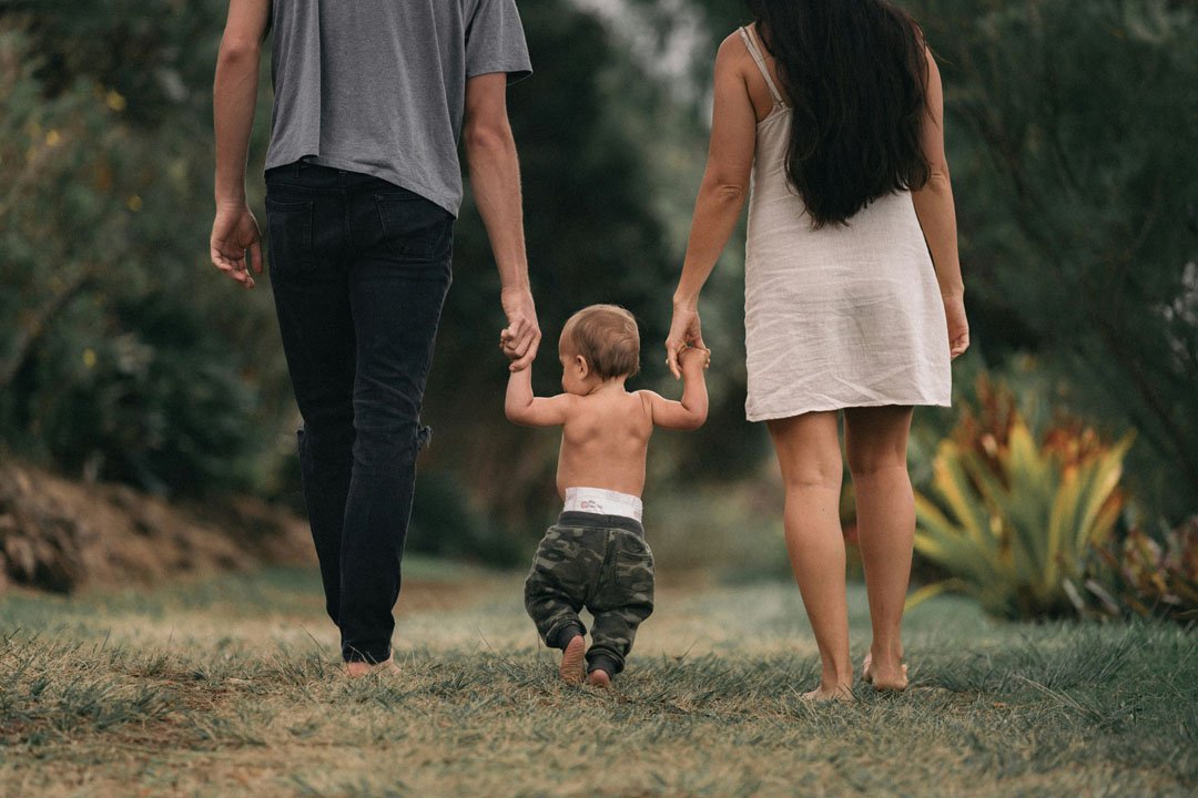 dad-and-mom-holding-their-son-by-jakob-owens-at-unsplash